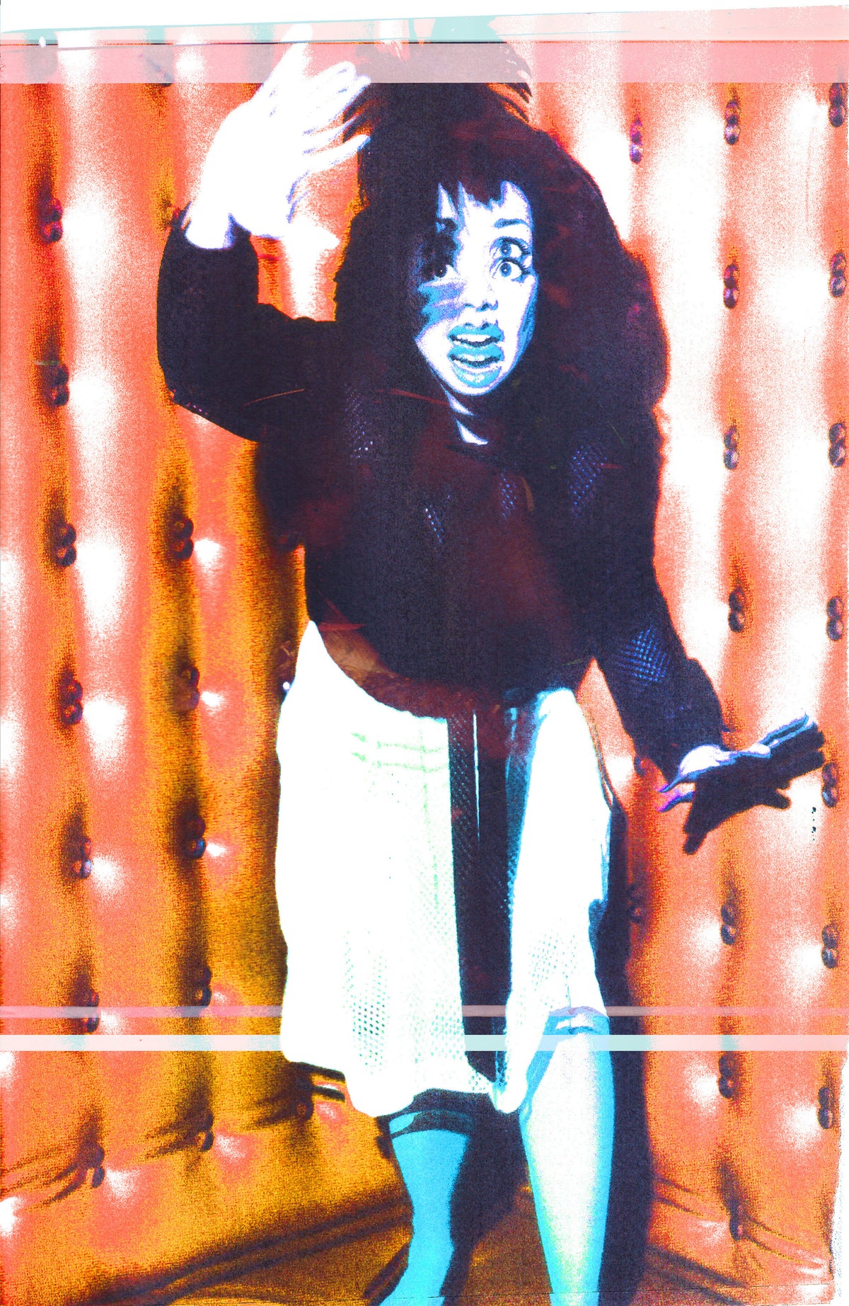 A stylized, high-contrast portrait of a person with dark curly hair, wearing a dark long-sleeve top, a white skirt, and blue tights, standing in front of a tufted orange-brown padded backdrop.